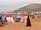 Women in traditional outfits playing tennis on the beach in Agadir, Morocco.