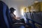 Women traveling by an airplane. Women sitting by aircraft window and looking outside.