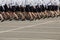 Women in a uniform of police in black skirts and white shirts march a system on the parade-ground