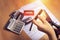 Women use scissors to cut credit cards in hand with many credit card and statement on table for background