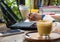 Women are using pencil to write books. Placed on a notebook computer on a wooden desk. Have coffee and a smartphone as a face blur