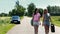 Women walking on road with rusty canister in hand