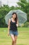 Women walking in the umbrella in the lawn