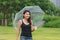 Women walking in the umbrella in the lawn