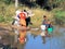 Women wash colorful clothes on the banks of a river, Madagascar