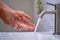 Women wash their hands with soap and water from the tap in the bathroom. Good hygiene and hand washing, prevent germs