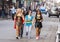 Women wearing funny costumes celebrating famous Mardi Gras carnival on the street in French Quarter.