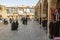 Women wearing islamic modest clothing passing by the shops of Islamic outfit sellers offering black hijab, veils and scarfs