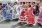 Women wearing traditional Sevillana dresses and dancing a Sevillana at the Seville April Fair.