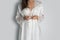Women wearing white nightgown & long sleeve satin robe with floral lace