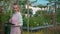 Women worker in garden centre. Using tablet. Gardener