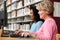 Women working on computers in library