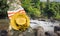 Women yellow hat and bag on tree in summer relax waterfall background