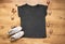 Womens Black marl effect T shirt mock up on wooden backdrop with Christmas baubles and sneakers