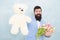 Womens day. Formal businessman with teddy bear toy. spring bouquet. 8 of march. bride groom at wedding party. bearded