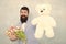 Womens day. Formal businessman with teddy bear toy. spring bouquet. 8 of march. bride groom at wedding party. bearded