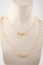 Womens gold double chain with beads, golden stones on white mannequin