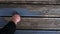 Womens hands Painting faded old Garden Wooden Decking With Grey Paint