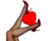 Womens legs in black tights and maroon high heel shoes holding red heart ballon