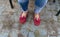 Womens legs in jeans and red loafers