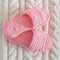 Womens pink Slippers on a white knitted wool carpet