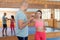 Womens self-defense workout with personal trainer, fighting training in gym