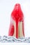 Womens shiny patent red stiletto heels and steel chain on white background