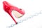 Womens shiny patent red stiletto heels and steel chain on white background