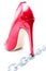 Womens shiny patent red stiletto heels and steel chain on white background