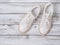 Womens shoes white sneakers on  wooden background. Spring summer collection. Fashion concept. Flat lay