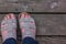 womens white feet standing in sandles on old wooden boards