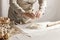 Womenâ€™s hands, flour and dough. A woman is preparing a dough for home baking.