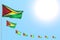 Wonderful any holiday flag 3d illustration - many Guyana flags placed diagonal on blue sky with space for text
