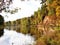 Wonderful autumn landscape with multicolored trees and quiet river.