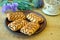 Wonderful biscuit cakes poured with chocolate stand on clay plate