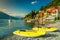 Wonderful cityscape and harbor with yellow kayaks, Varenna, Lake Como