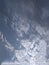 An wonderful close up of a striking view of a pattern of clusters of white clouds in blue sky with sunlight in the winter