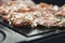 Wonderful detail of grilling pork neck meat on a granite stone laid on the heat of the fire. Meat sprinkled with salt, basil,