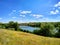 Wonderful Dnieper river, bridge, field grasses, willows, blue sky.