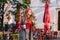 Wonderful female model in gray clothes walking down the street with cup of coffee. Glamorous slim girl in beret looking