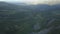 Wonderful flight to the beautiful valley with forest in the mountains. Clip. Beautiful green valley surrounded by