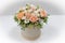 Wonderful flower arrangement in a hat box on a light background