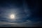 A wonderful full moon has descended over Ukrainian carpathians in blurry clouds