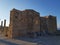 Wonderful grungy wall of old ruins brick building against cloudless blue sky on sunny day.