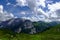 wonderful high mountains with green meadow and clouds on the sky