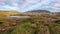 Wonderful icelandic landscape. grass land, lake, high multi-colored mountains, and beautiful sky