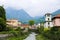 Wonderful italian Mandello landscape with lovely houses, trees and mountains in background.