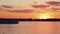 Wonderful landscape of lake, coast line, floating ferry boat at cute orange sunset.