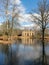 Wonderful landscape with old manor ruins, early spring, beautiful blue sky with white clouds, small pond with beautiful