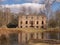 Wonderful landscape with old manor ruins, early spring, beautiful blue sky with white clouds, small pond with beautiful